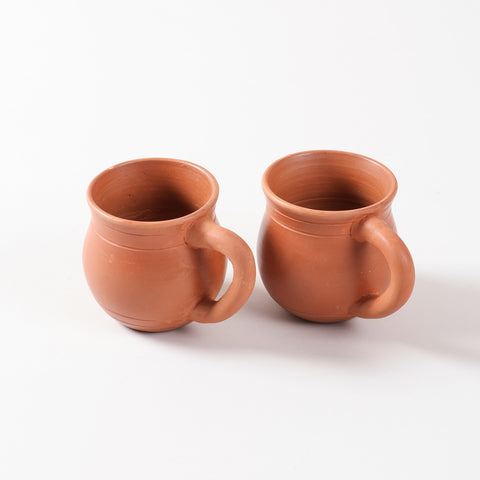 Set of two handcrafted terracotta kulhad cups with natural clay finish displayed on a plain background