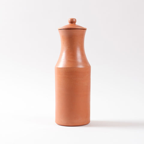 Front view of a terracotta water carafe and lid highlighting the natural clay finish and handcrafted earthen design
