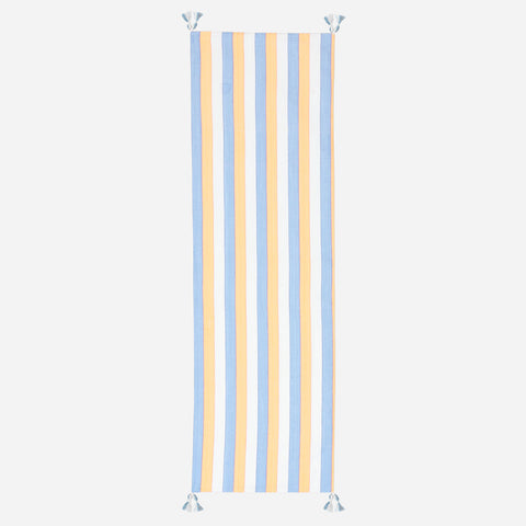 Full-length handwoven cotton table runner featuring blue, orange, and white stripes with tasselled ends displayed on a plain background