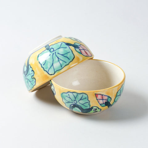 Hand-painted Water Lily ceramic katori set with one bowl upright and another resting upside down at an angle, highlighting handcrafted Khurja ceramic detailing