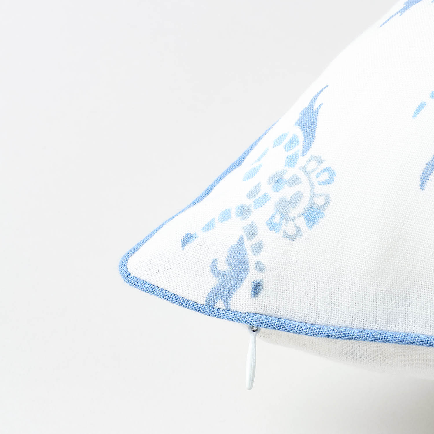 Hand block printed blue swirl motif on white cotton linen fabric highlighting handcrafted detailing