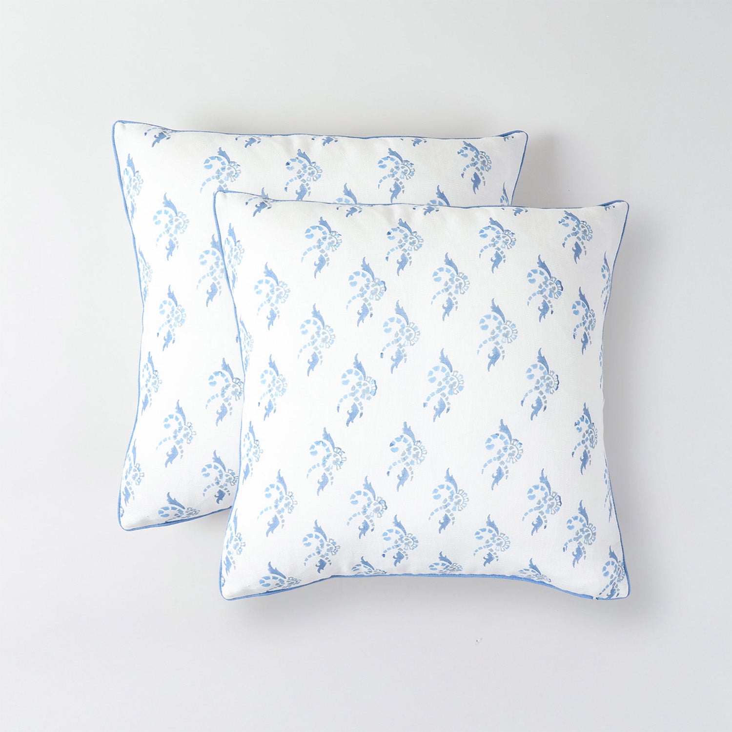 Set of two white and blue artisan cushion covers for coordinated sofa and chair styling