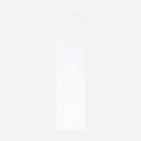 Full-length embroidered table runner featuring white daisy motifs on a white cotton base displayed on a plain background