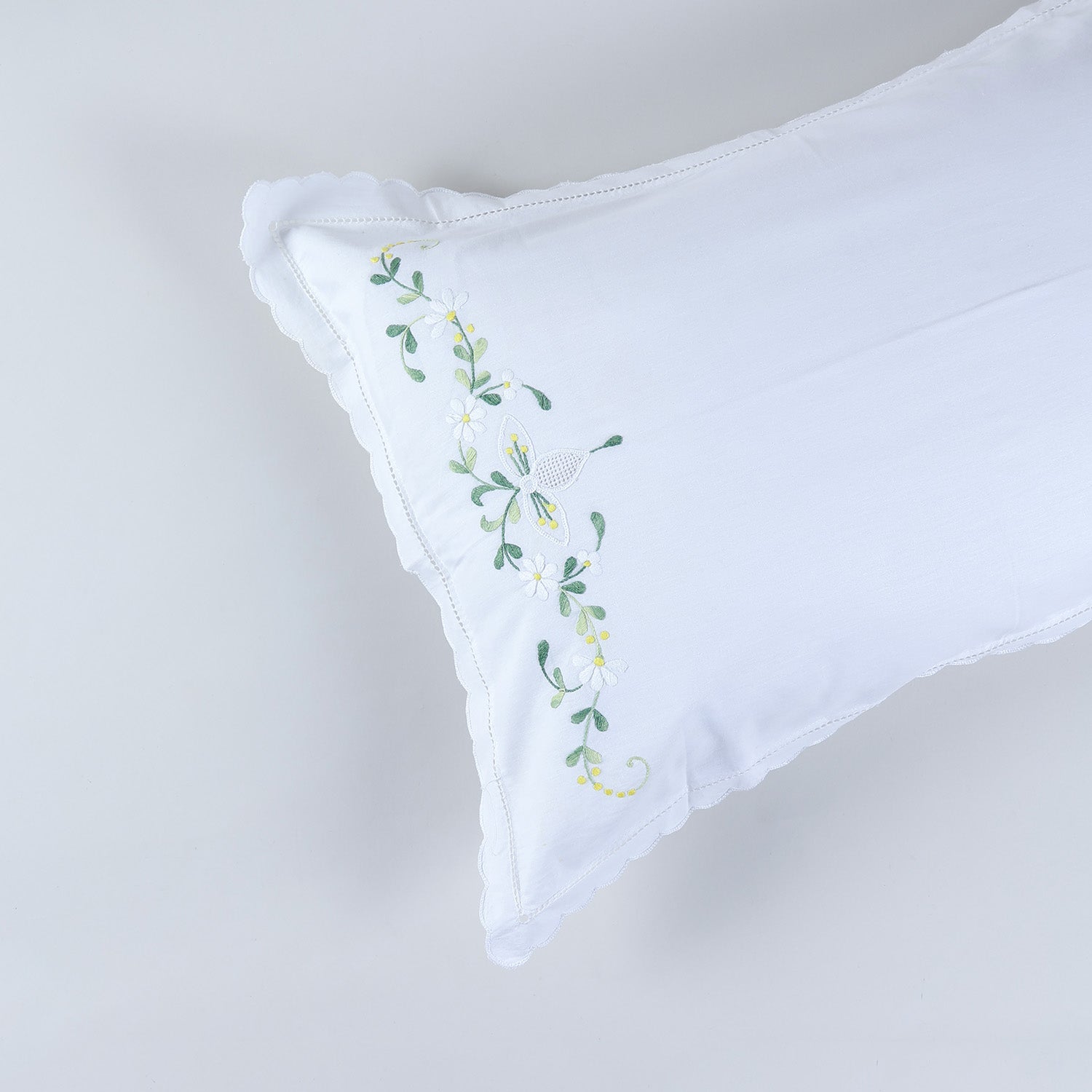 Close-up of daisy flower chikankari embroidery and handcrafted detailing on cotton pillow cover