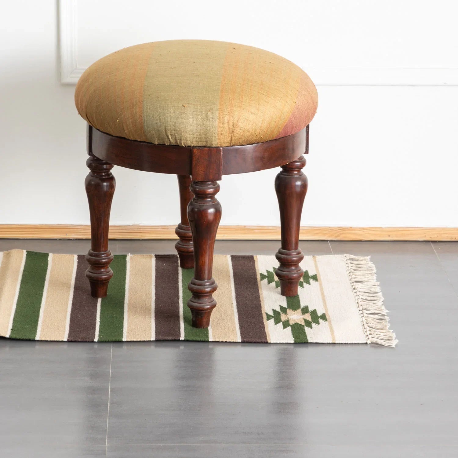 White and green handwoven cotton dhurrie runner styled in a hallway, adding texture and artisan charm to home decor