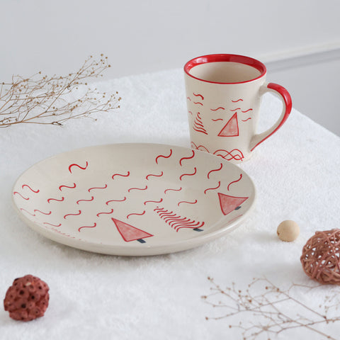 Christmas-themed ceramic breakfast set arranged with cookies and hot chocolate creating a festive holiday dining experience