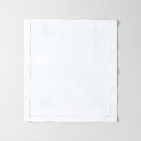 Folded white cotton table runner showcasing delicate chikankari wild floral embroidery and premium handmade craftsmanship