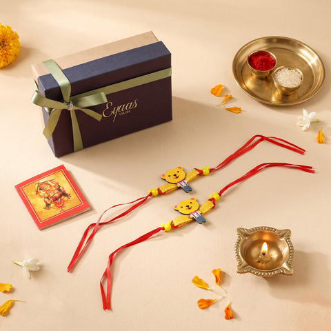 Handcrafted Wooden Teddy Bear Kids Rakhi Set of 2. Cartoon rakhi for brothers, beautifully presented in a festive gift box with red satin ribbon, ready for Raksha Bandhan gifting.