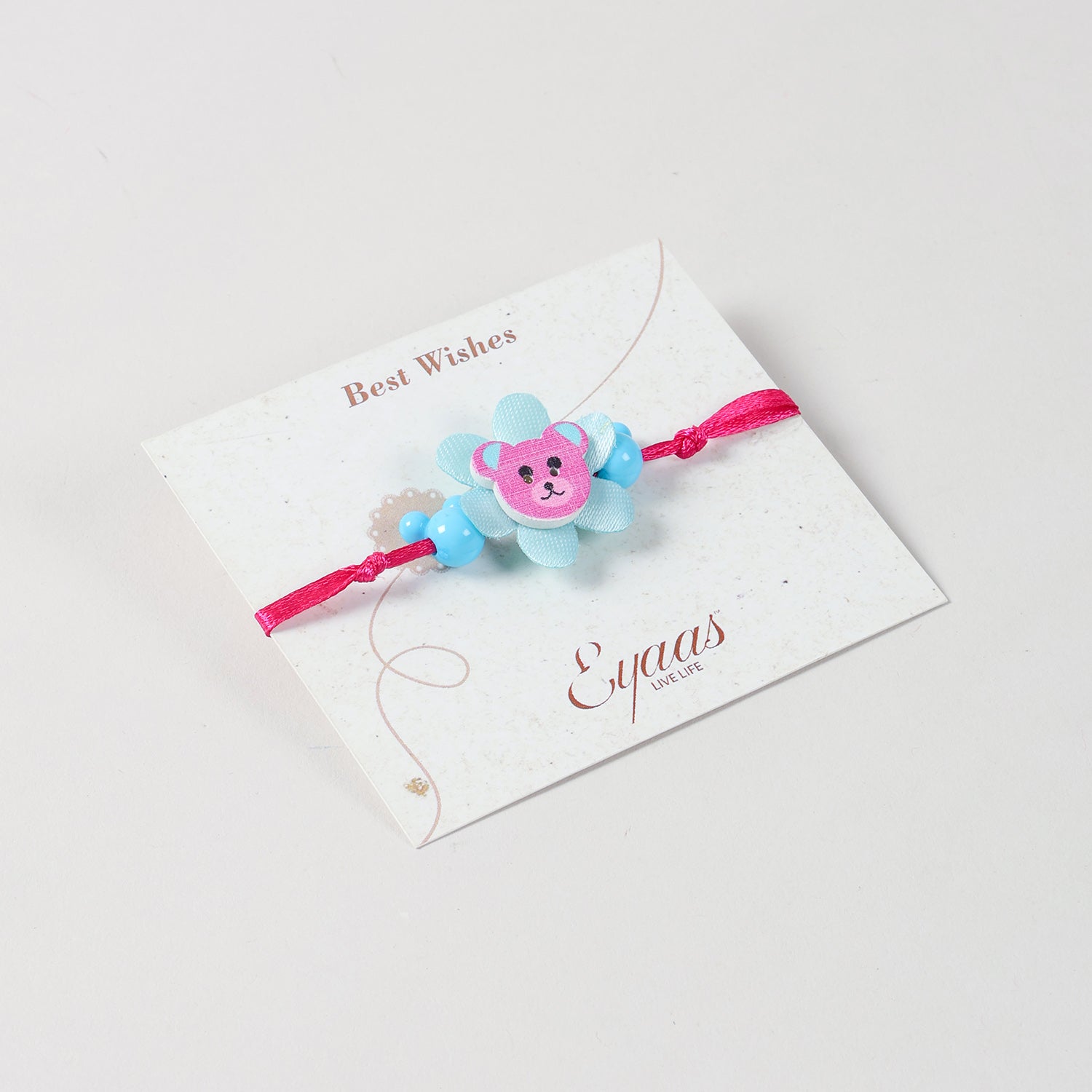 Wooden Teddy Bear Kids Rakhi Set of 2 in Blue & Pink, attached to a festive Best Wishes card for Raksha Bandhan gifting 
