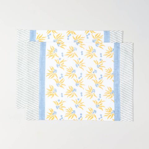 Pack of two floral block printed cotton placemats in yellow and blue for everyday table settings