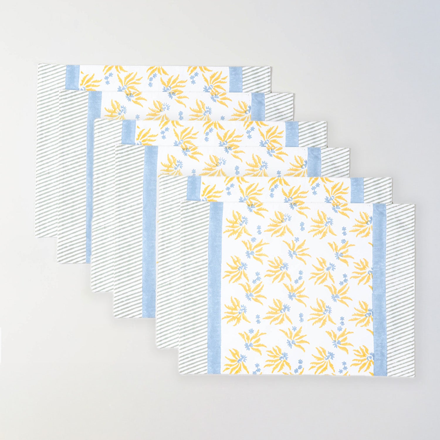 Pack of six floral cotton table mats in yellow and blue for gatherings and festive table settings