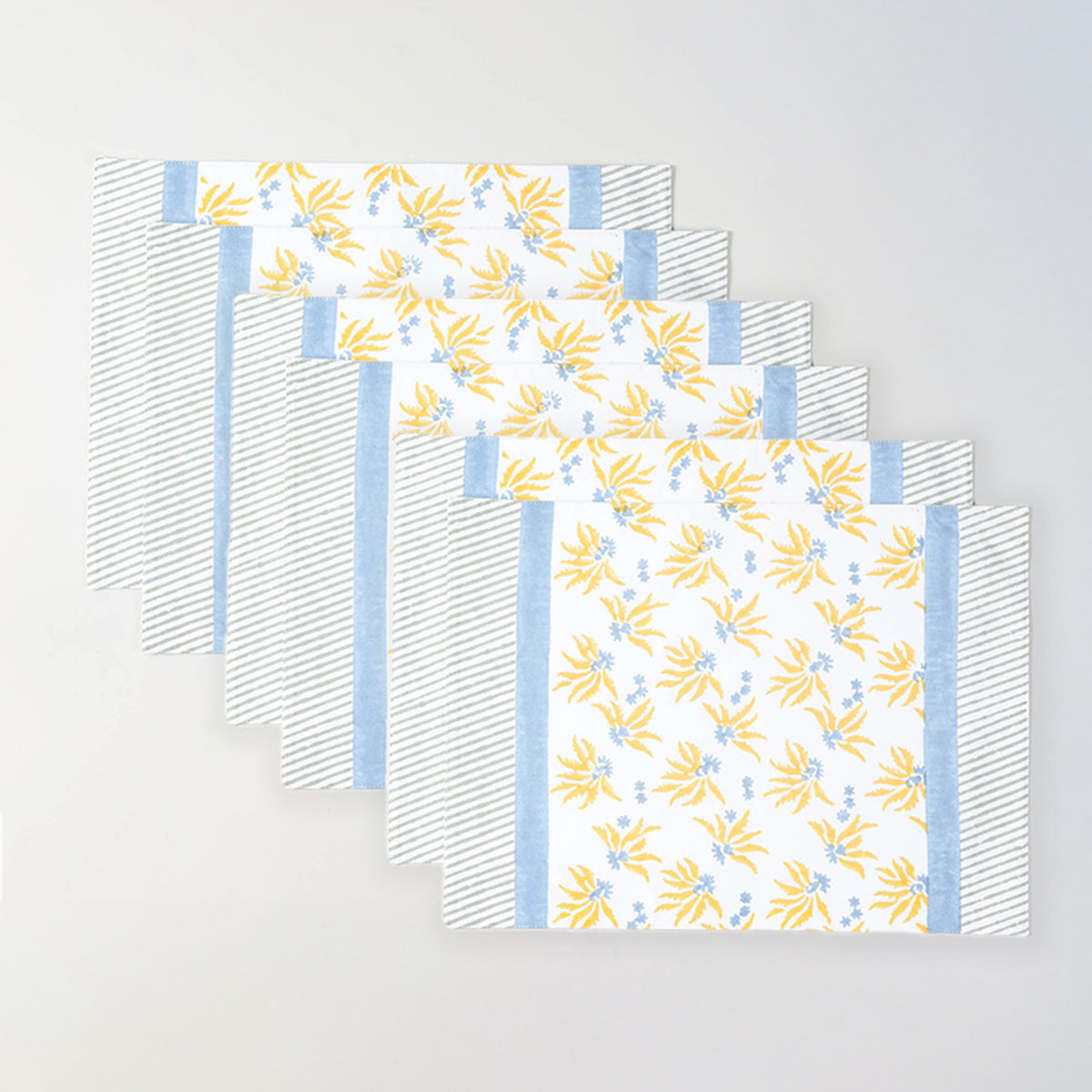 Pack of six floral cotton table mats in yellow and blue for gatherings and festive table settings