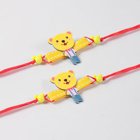 Close-up of the handmade yellow Cartoon Teddy Bear Wooden Kids Rakhi Set of 2, highlighting the wooden teddy design and red ribbon details.