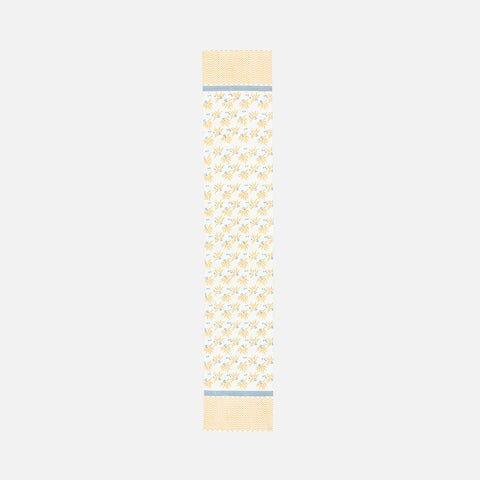 Full length table runner with yellow and blue floral motifs arranged in a diagonal pattern