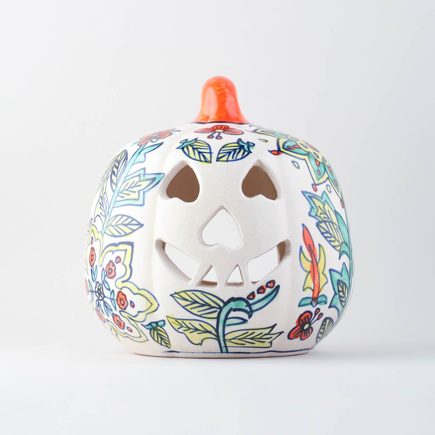 Hand-painted yellow floral ceramic pumpkin tea light holder with decorative cutwork handcrafted in Khurja