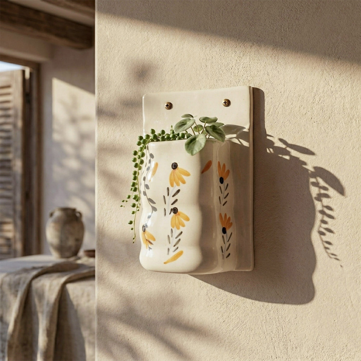 Wall-mounted ceramic flower pot styled with indoor greenery, adding a fresh and decorative touch to a modern room wall decor setup.