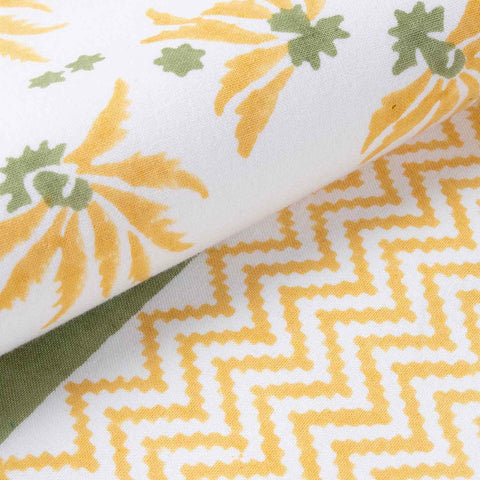 Close-up view of yellow floral block print patterns on a handcrafted cotton table runner with textured fabric detail