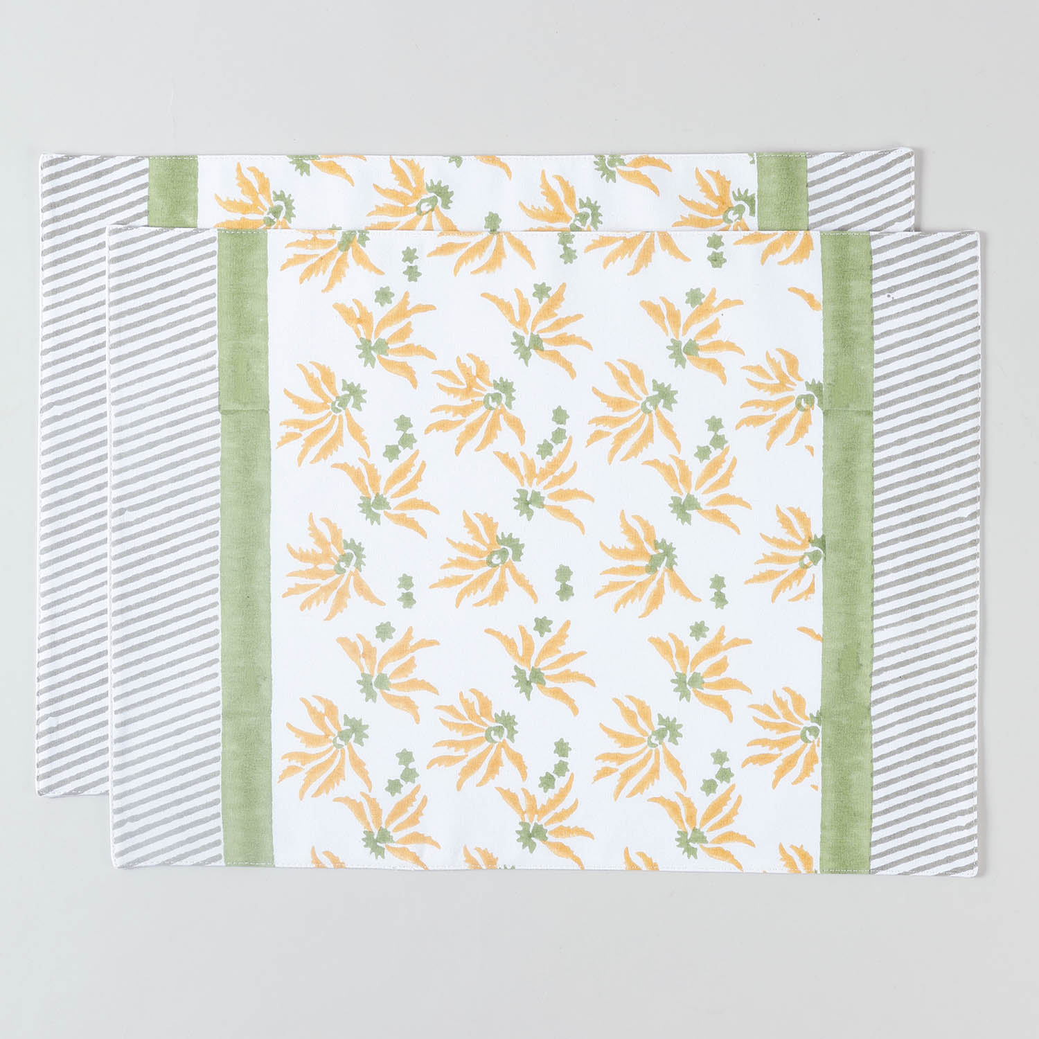 Pack of two cotton placemats featuring yellow and green floral block printed patterns