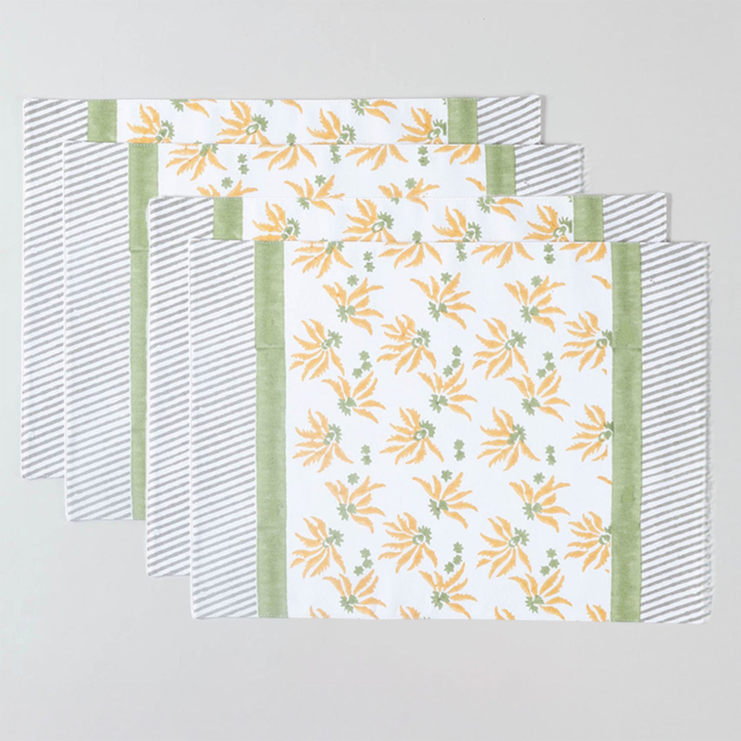 Set of four hand block printed placemats with yellow and green floral pattern for family dining