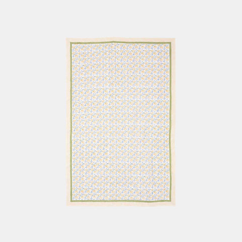 Yellow lily floral hand block printed cotton table cloth featuring yellow blossoms and blue vine motifs on a white base