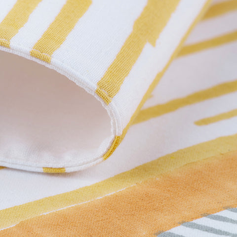 Detailed yellow line and dash block print with grey border accents on handcrafted cotton placemat