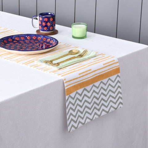 Yellow stripe block printed table runner styled with coordinated tableware for cheerful dining table decor