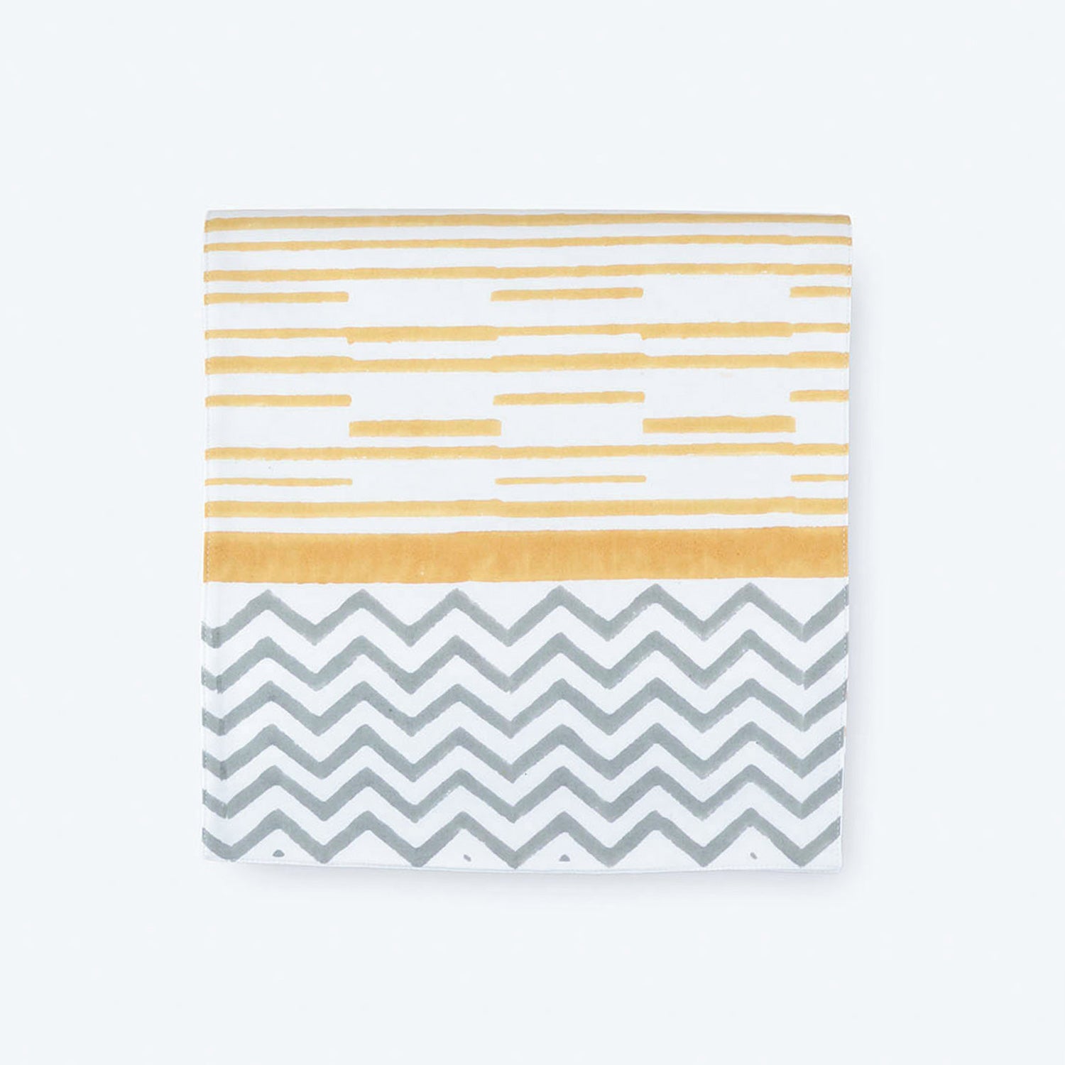 Folded cotton table runner featuring yellow striped block print with handcrafted border detailing