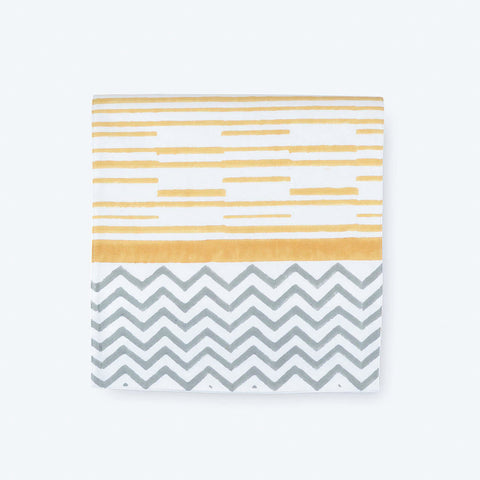 Folded cotton table runner featuring yellow striped block print with handcrafted border detailing