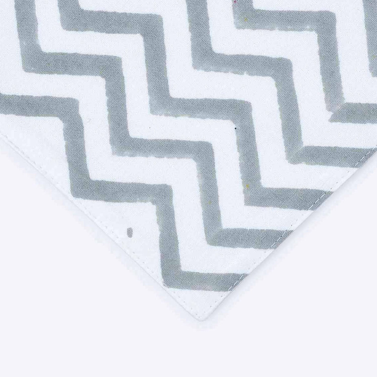 Close-up of yellow line motifs grey zigzag border and orange accent stripe on cotton table runner