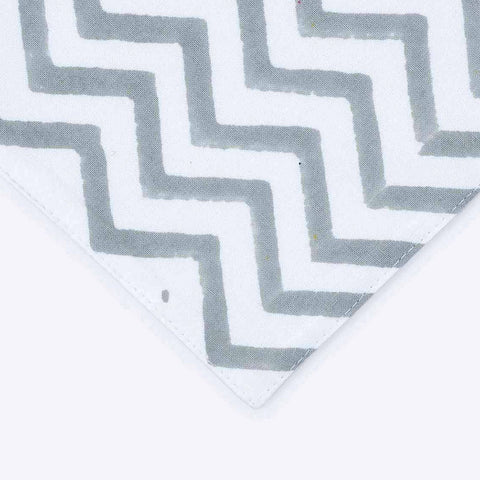 Close-up of yellow line motifs grey zigzag border and orange accent stripe on cotton table runner