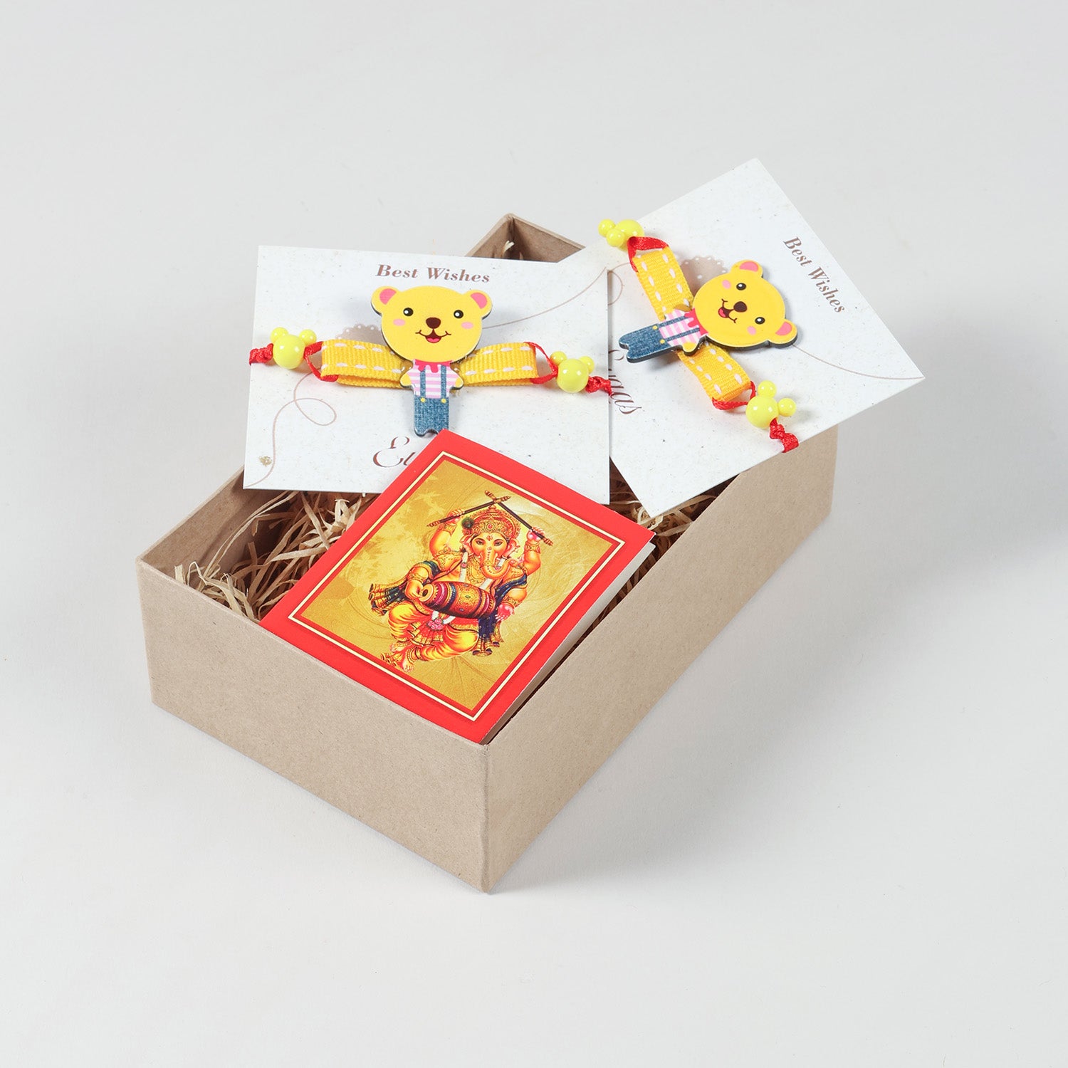 Yellow Teddy Bear Wooden Kids Rakhi Set of 2 neatly arranged inside a festive gift box for a thoughtful Raksha Bandhan surprise