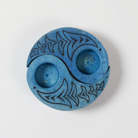 Top view of hand carved wooden T-light candle holders in a Ying Yang bird design, showcasing detailed craftsmanship and decorative appeal