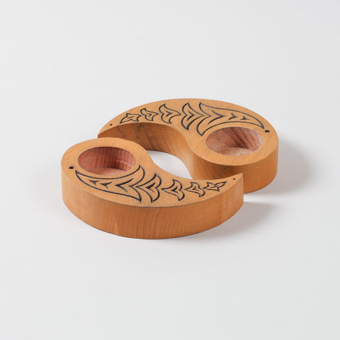  Angled view of hand carved wooden T-light holders in yellow, featuring bird motifs and a Ying Yang shape, perfect for decorative candle holder displays