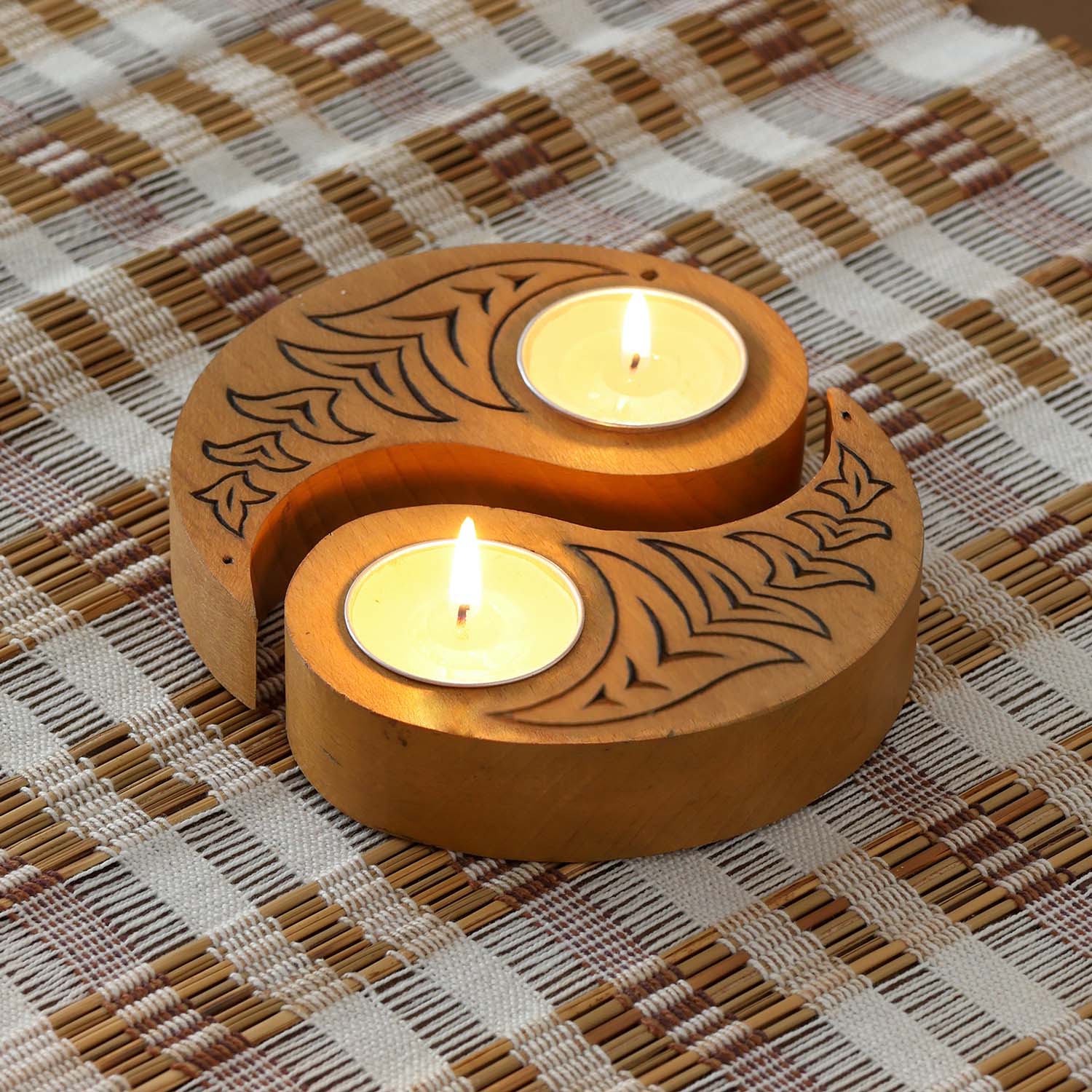and carved wooden Ying Yang bird T-light holders set of 2 in yellow, displayed with lit tea lights on a woven mat, ideal for handmade decor and Diwali decor