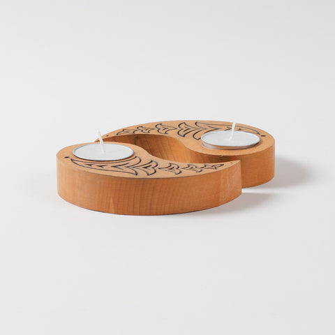  Side angled view of yellow wooden tea light candle holders with bird carvings, displayed with unlit T-lights on a plain background