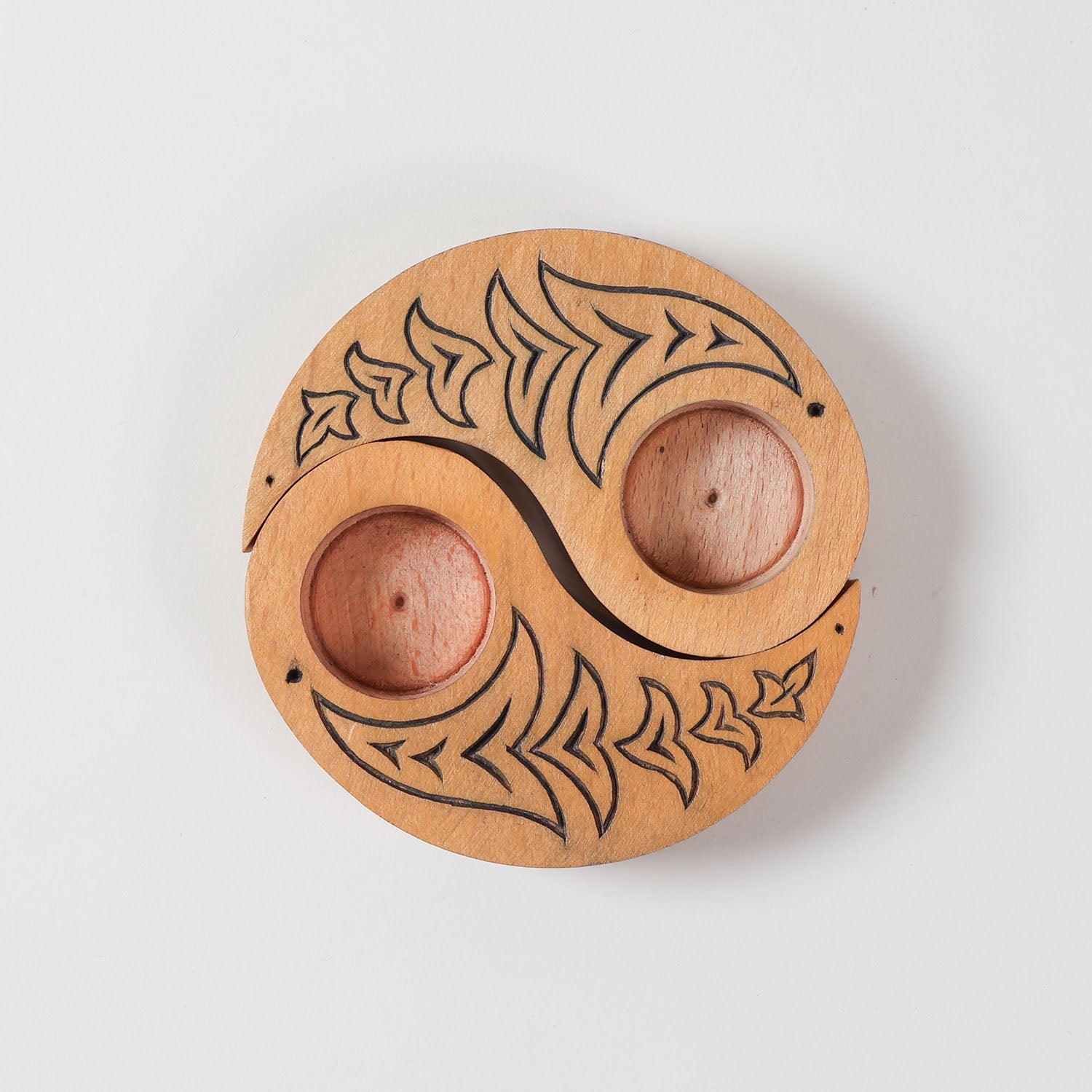  Top view of hand carved wooden T-light candle holders in a Ying Yang bird design, showcasing detailed craftsmanship and decorative appeal