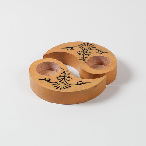 Angled view of hand carved wooden T-light holders in yellow, featuring floral motifs and a Ying Yang shape, perfect for decorative candle holder displays