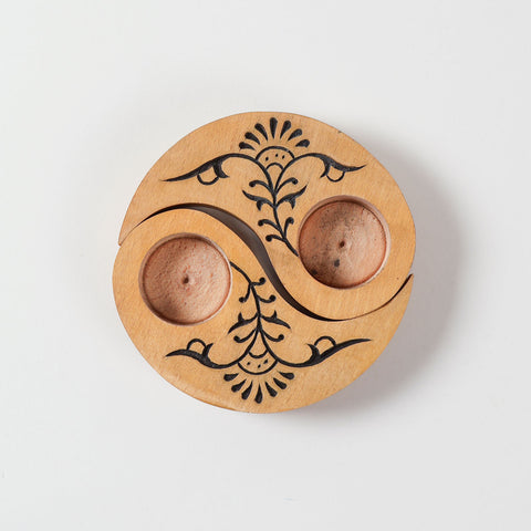 Top view of hand carved wooden T-light candle holders in a Ying Yang floral design, showcasing intricate floral carving and handcrafted details