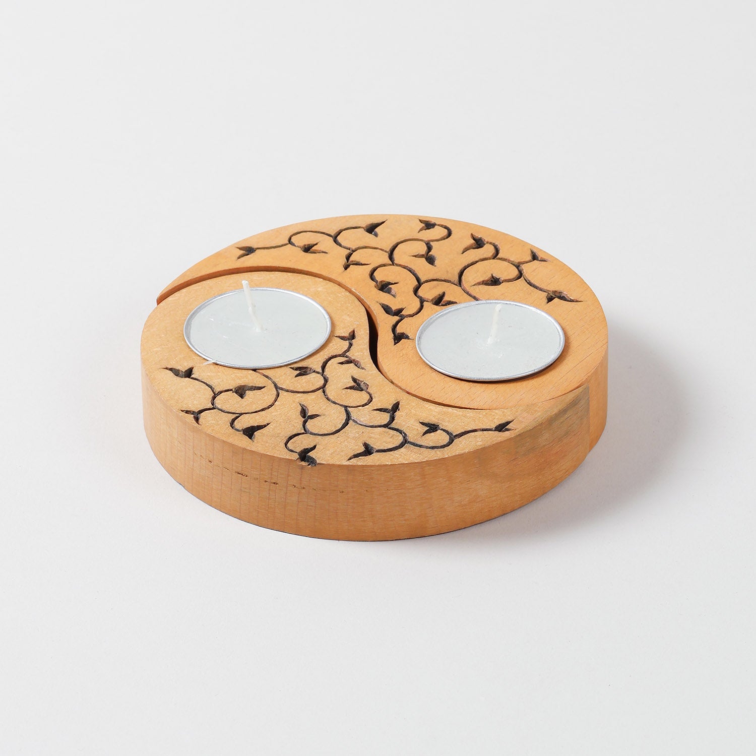 Yellow wooden T-light holders set of 2 featuring hand carved leaf motifs and Ying Yang design, displayed on a plain background without candles