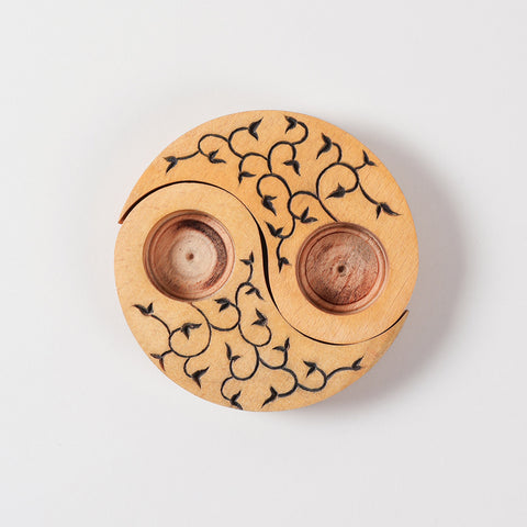Top view of hand carved wooden T-light candle holders in a Ying Yang leaves design, showcasing detailed craftsmanship and decorative appeal