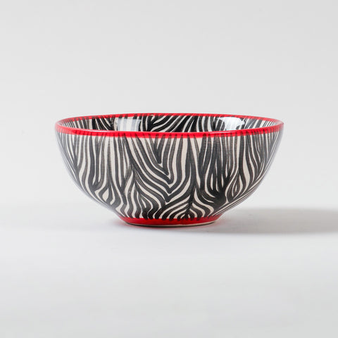 Handmade African ceramic bowl featuring a zebra stripe pattern and contrasting rim, suitable as a snack bowl, salad bowl, or decorative tableware piece