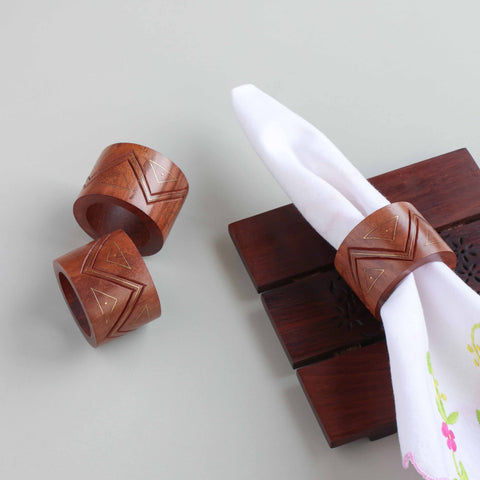 Handcrafted wooden napkin rings with brass inlay styled on a dining table for an elegant table setting decor